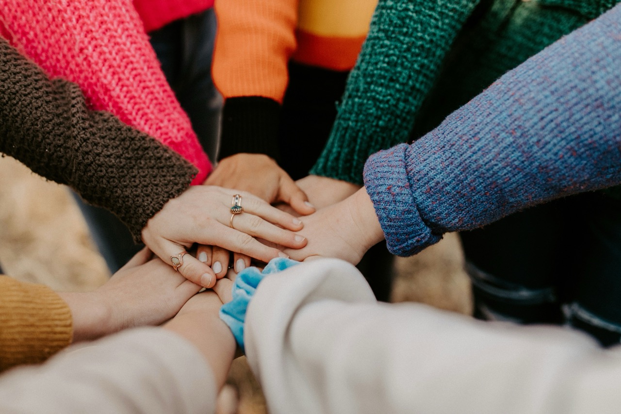 Hands holding each other to show teamwork.