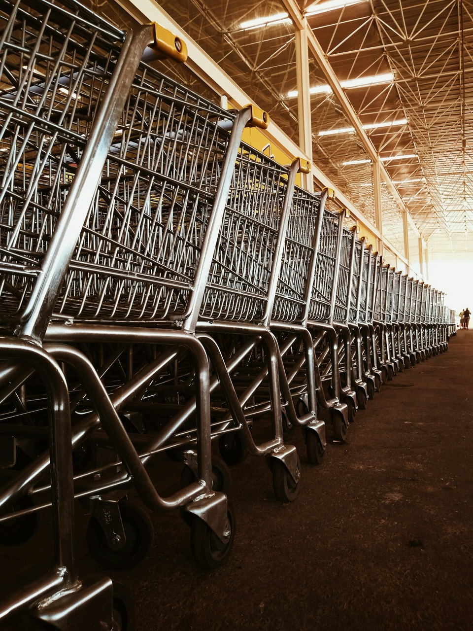 Many shopping carts in front of a store.